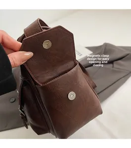 Detail showing the magnetic snap closure on the dark brown vintage PU leather handbag