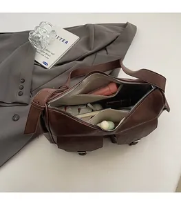Macro view of interior storage space of the brown faux leather crossbody bag