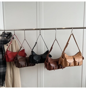 Macro detail of retro multi-pocket leather bags in various colors on a display