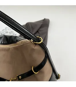 Detail of high-quality golden hardware and mixed material texture on the handbag