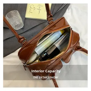 Spacious interior of brown patent leather tote bag showing storage for daily items