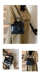 Detail of a black glossy leather multi-use bag showing buckle straps and silver hardware