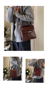 Detail of vintage dark brown faux leather handbag with adjustable strap and metallic clasp