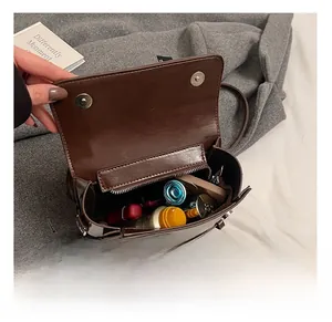 Interior view of brown leather bag showing spacious capacity with inner zipper pocket