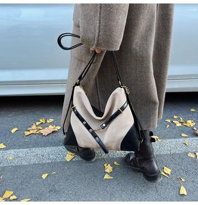 Close-up of contrast large tote bag with beige suede and black leather stitching