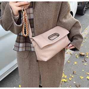 Close-up of pleated leather shoulder bag with silver hardware and braided strap detail