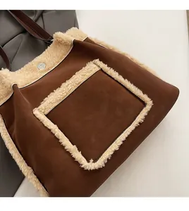 Close-up of brown suede bucket bag featuring creamy faux shearling trim and magnetic snap