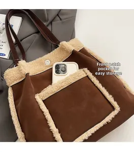 Detail of faux shearling tote bag with a front pocket for phone storage and magnetic buckle