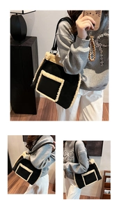 Detail of black autumn winter tote bag featuring beige faux shearling trim and long straps