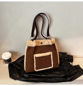 Detailed view of brown suede tote bag with white plush trim and leather straps