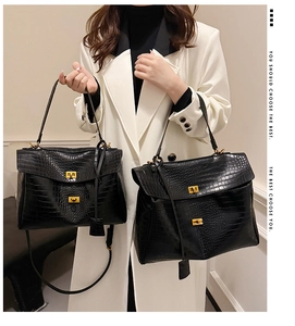 Detail of black crocodile texture bags in medium and large sizes with gold twist locks