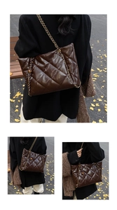 Detail of dark brown glossy quilted tote bag with chain strap and metallic pendant
