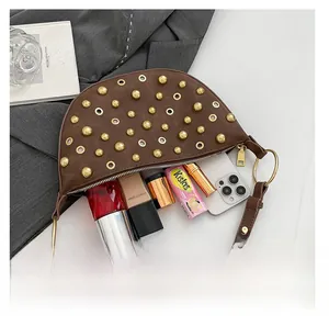 Vue intérieure du sac selle marron montrant l'espace pour téléphone et maquillage