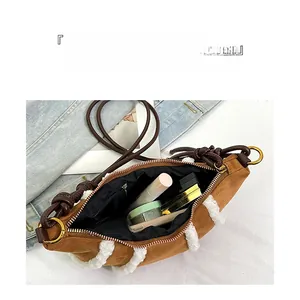 Detail showing the large interior capacity of this plush faux fur crossbody crescent bag