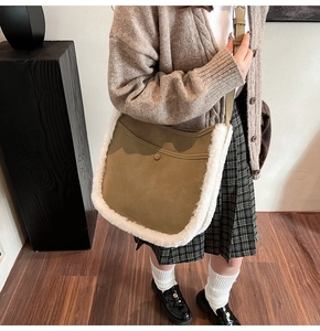 Close-up of khaki saddle bag featuring white faux fur trim and adjustable leather strap