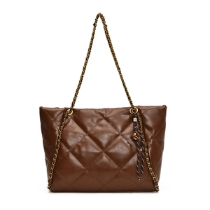 Stylish brown quilted tote bag with gold chain straps and letter M pendant on white background