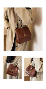 Detail view of vintage brown crossbody bag with gold flower clasp and smooth PU leather finish