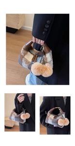 Detail view of plaid plush handbag with brown leather handles and cherry pompom charms