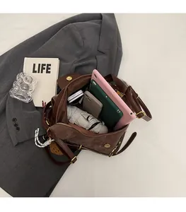 Brown suede tote interior showing space for tablet, phone, umbrella and makeup
