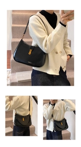Detail of a chic black glossy leather shoulder bag featuring a classic gold clasp buckle