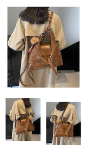 Detail of matte brown tote bag with plush bear charm and striped scarf decoration