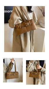 Detail showing vintage brown leather texture and silver metal buckles on biker bag
