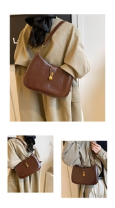 Macro shot of retro brown leather shoulder bag featuring gold buckle and polished finish