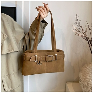 Detail of vintage brown shoulder bag with leather buckle straps and silver hardware