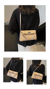 Detail of crocodile pattern texture and silver buckle on the stylish cream armpit bag