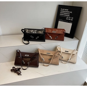 Group display of crocodile texture handbags in five colors with classic twist locks