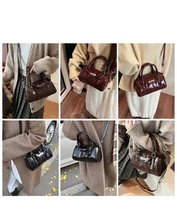 Multiple views showing styling of the glossy cylinder handbag in black, brown and red