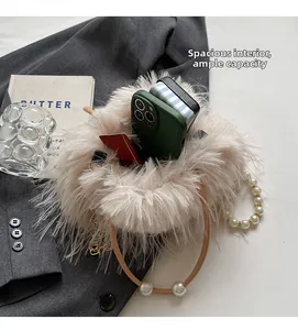 Spacious interior of plush apricot bucket bag with pearl handle and shoulder strap