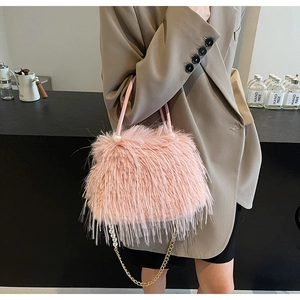Pink faux fur bucket bag with pearl handles and a detachable golden chain strap