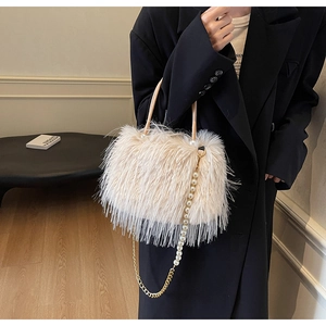 Close-up of leopard pattern bucket bag with white faux fur, pearl chain and gold hardware