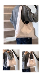 Close-up of glossy pink hobo shoulder bag with elegant tie detail and wide strap design