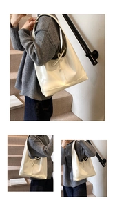 Detailed view of the white glossy bow-accented shoulder bag styled with casual wear