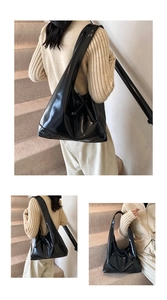 Detail of a black glossy leather hobo bag with a wide strap and side drawstring accent