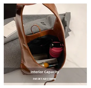 Top-down macro view showing spacious interior with zipper pocket in brown tote bag