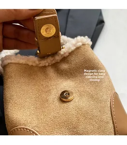 Detail showing the magnetic snap closure and fuzzy shearling trim on the brown suede bucket bag
