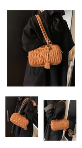 Detail view of the brown leather pleated shoulder bag, showcasing fine ruching and hardware.