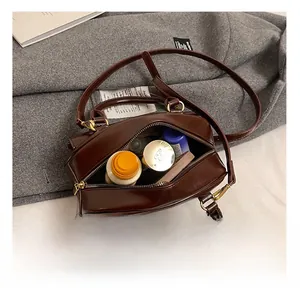 Macro view of brown bowling bag interior showing large capacity and smooth zipper