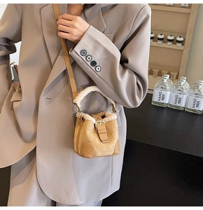 Close-up of mini bucket bag with camel suede, beige faux fur trim and leather buckle