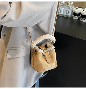 Detail of vintage bucket bag featuring plush faux fur trim and gold buckle hardware
