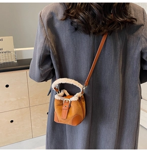 Brown suede mini bucket bag with white faux fur trim and adjustable crossbody strap