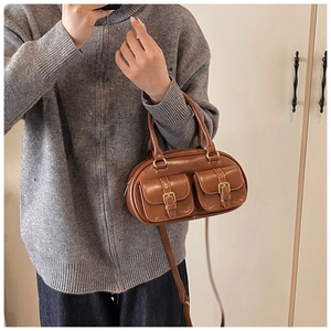 Brown retro leather bowling bag detail showing front double pockets and gold buckles