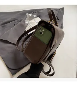 Close-up of vintage brown leather backpack featuring a functional rear pocket for smartphone