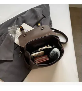 Deep brown matte leather backpack interior showing high capacity for phone and umbrella