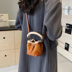 Maillard style brown suede bucket bag with beige plush trim and leather strap