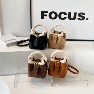 Fuzzy suede bucket bag with faux shearling trim and adjustable strap in four neutral colors