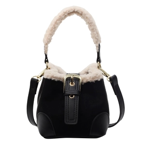 Black bucket bag with beige plush trim and gold buckle for autumn winter fashion style